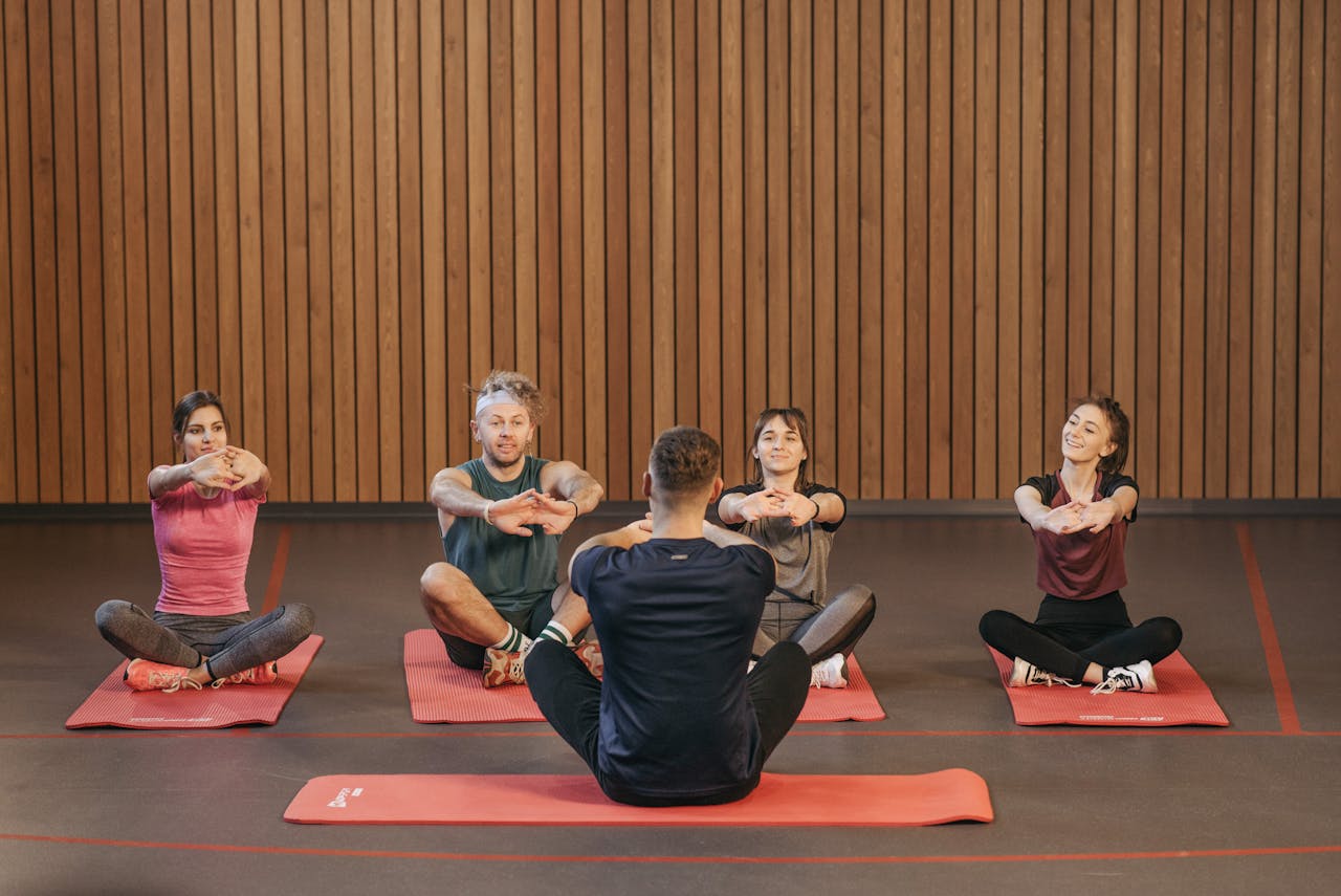 A diverse group practicing yoga in a studio with a focus on wellness and mindfulness.